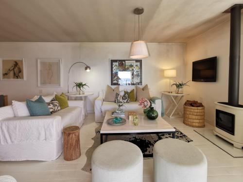 uma sala de estar com um sofá e uma mesa em Village Square 10 em Plettenberg Bay
