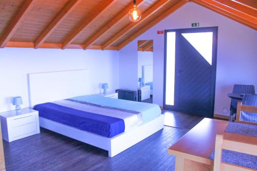 a bedroom with a bed and a table and chairs at Studio One | Massapez | Fajã da Ovelha | Calheta in Fajã da Ovelha