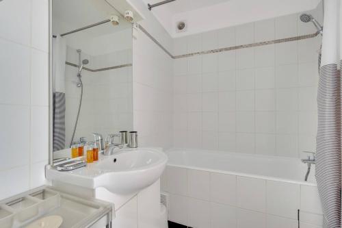 a white bathroom with a sink and a shower at Luminous Apt 4pers with balcony in Paris