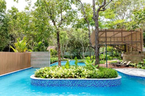 a swimming pool with a garden in the middle at Minera Hot Springs Binh Chau in Binh Chau