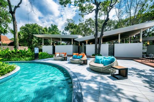 an outdoor patio with a swimming pool and a house at Minera Hot Springs Binh Chau in Binh Chau