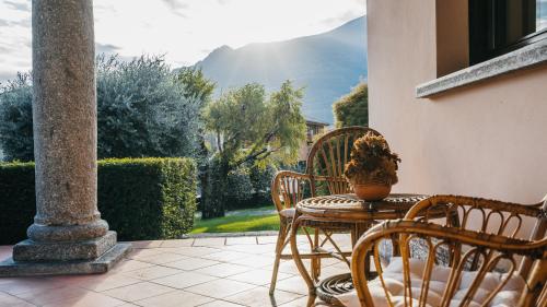 a table and chairs on a patio with a plant at Villa Dervio in Dervio