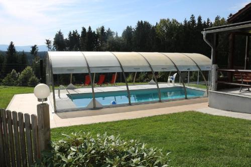 a house with a swimming pool with a building at Gästehaus Penzkofer F**** in Viechtach