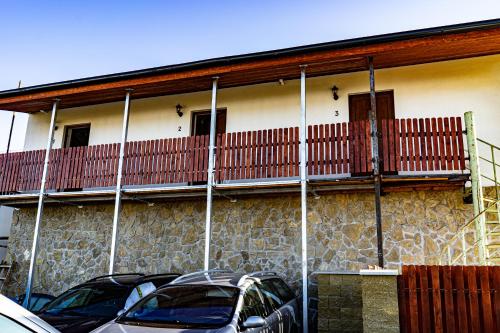 a building with cars parked in front of it at Penzion Kera in Rossitz