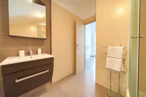 a bathroom with a sink and a mirror at Villa Vrh in Krk