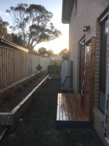 a backyard with a fence and a refrigerator at Seabreeze Haven -Wifi, Netflix, pet friendly beach house in Cowes