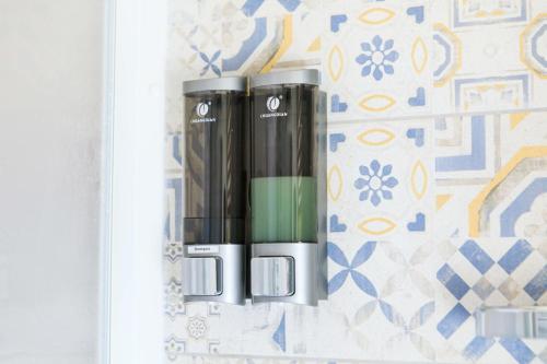 two black and green bottles sitting on a shelf at Desidora B&B in Mirabella Eclano