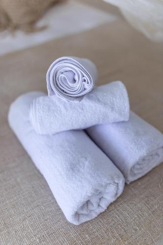 a pile of towels sitting in a bath tub at The Manik Toya in Uluwatu