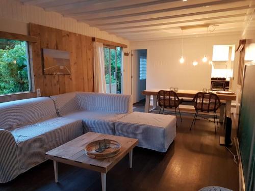 a living room with a couch and a table at Zeeuwse Landhoeve in Brouwershaven