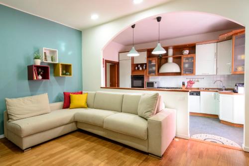 a living room with a couch and a kitchen at Monza Park Apartment in Monza