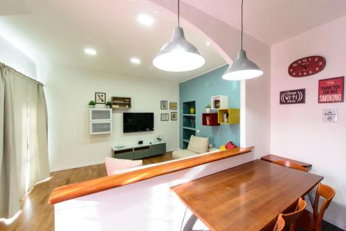 a dining room with a table and a couch at Monza Park Apartment in Monza