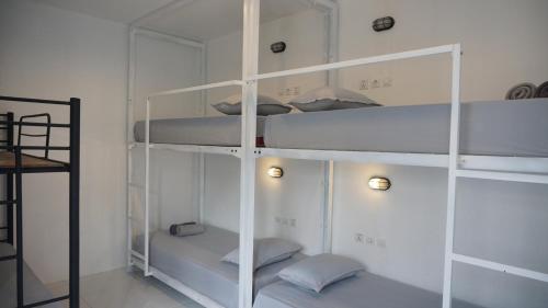 a room with white shelves with pillows on them at Wayang BnB in Yogyakarta