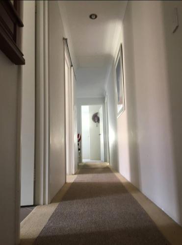 an empty hallway with a long hallwayngthngthngthngthngthngthngthngthngth at Telperio - Guest suite max 4 Guests in Bunbury