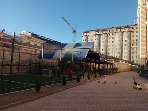 a building with a pavilion in the middle of a street at Apartments on Shevchenko in Tashkent