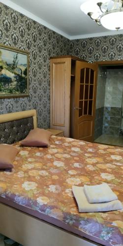 a bedroom with a large bed in a room at Хуторок in Smila