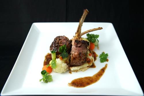 a plate of food with meat and vegetables on it at Olinia Airport Hotel in Katunayake