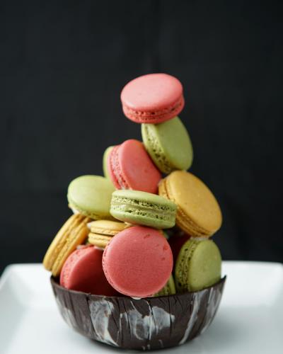 a stack of colorful macaroons in a bowl at Olinia Airport Hotel in Katunayake
