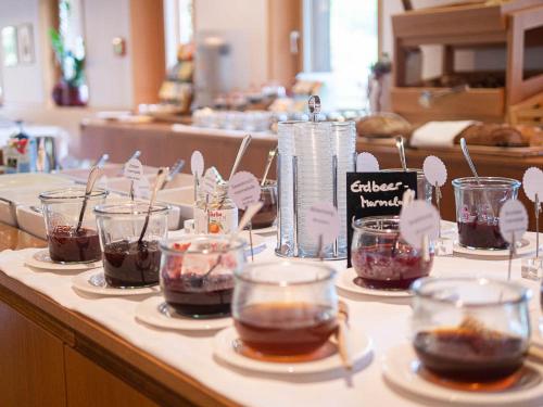 a counter with several cups of chocolate desserts on plates at Hotel Krone in Au in Au im Bregenzerwald