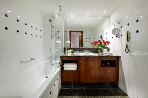 a bathroom with a sink and a shower at Eurostars Montgomery in Brussels