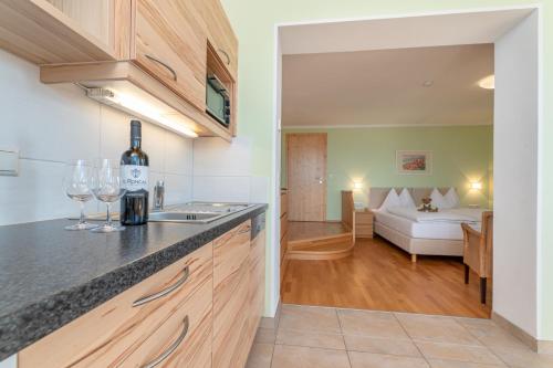 a kitchen with a counter top and a living room at Mösslacher's Ferienwohnungen in Hermagor