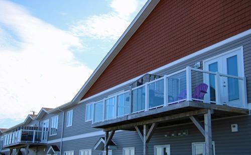 a building with a balcony on the side of it at The Killick Inn & Suites in Arnold's Cove