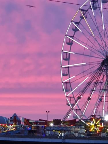 a ferris wheel at a carnival at sunset at Tobermory Hotel in Blackpool