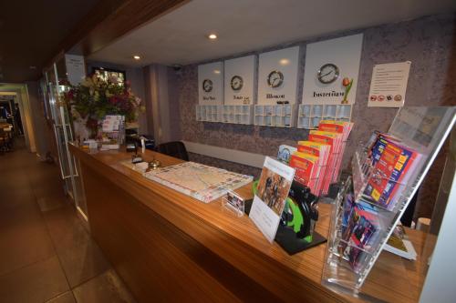 a counter in a store with clocks on the wall at Hotel Hermitage Amsterdam in Amsterdam