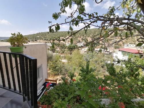 a balcony with a view of a mountain at Mhna guest house in Ajloun