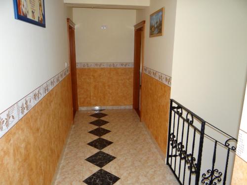 a hallway with a staircase with a tile floor at Marinica Apartman in Hajdúszoboszló
