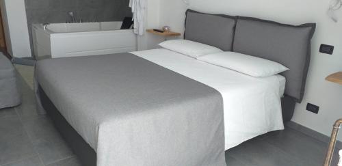 a bedroom with a large bed and a bath tub at La Stella delle Alpi in Vico Canavese