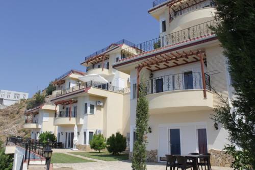 a building with tables and chairs in front of it at Blue Lagoon Village in Gazipasa