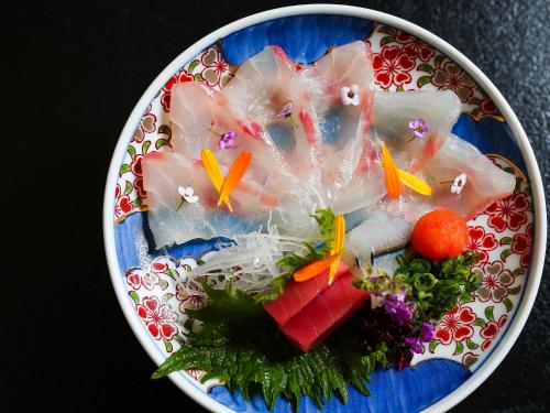 a plate of food on a table with food at Choseikan in Agano