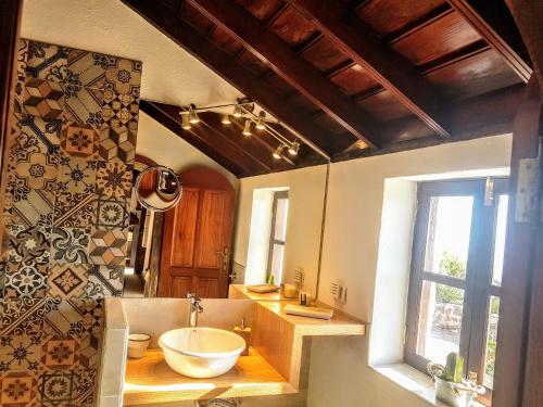 a bathroom with a sink and a large window at Casa Rural LAS TIAS II in Tijarafe