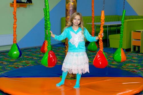 a little girl is playing on a swing at versal in Ternopilʼ