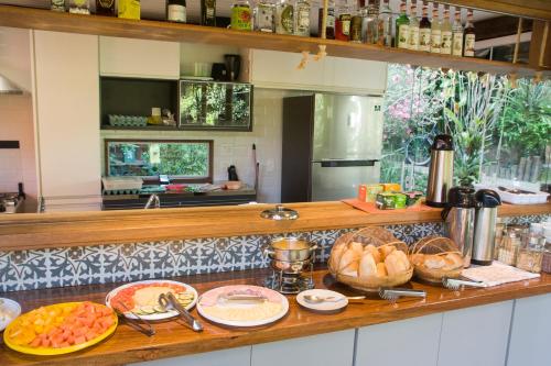 a kitchen with a counter with some food on it at Pousada Albatroz in Abraão