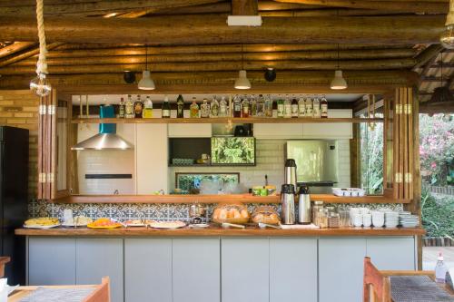a kitchen with a counter with food on it at Pousada Albatroz in Abraão