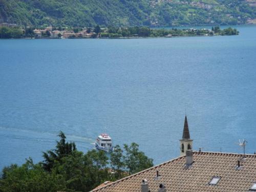 a building next to a large body of water at Agriturismo Piccolo paradiso in Pianello Del Lario