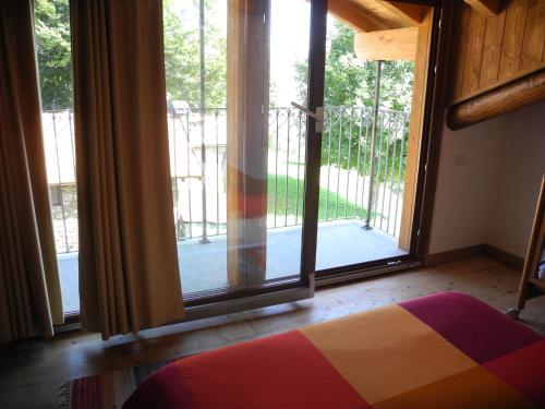 a bedroom with a large sliding glass door at Agriturismo Piccolo paradiso in Pianello Del Lario