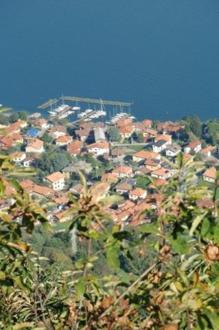 a town on a hill with houses and trees at Agriturismo Piccolo paradiso in Pianello Del Lario