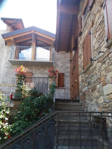 a stone building with a balcony and a door at Agriturismo Piccolo paradiso in Pianello Del Lario