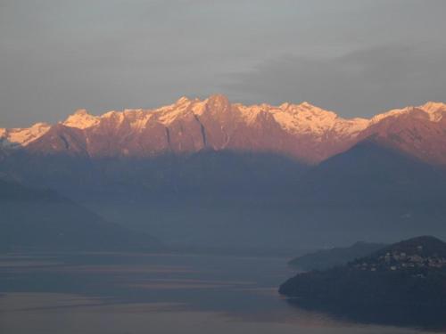 a large body of water with mountains in the background at Agriturismo Piccolo paradiso in Pianello Del Lario