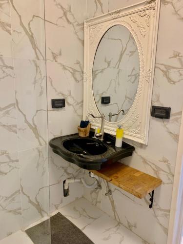 a bathroom with a black sink and a mirror at Shantell Luxury Apartment in Netanya