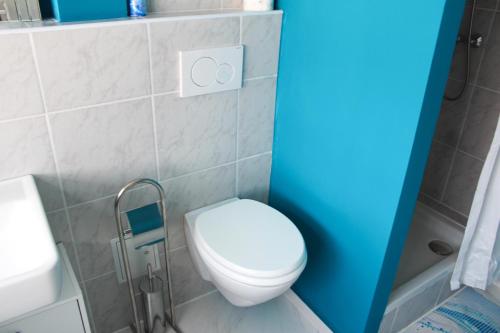 a small bathroom with a toilet and a sink at Skyhostel Friedrichshafen in Friedrichshafen