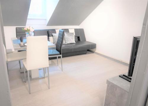 a living room with a couch and a table at MyHome Basel 3A44 in Saint-Louis