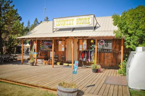 a building with a wooden deck in front of a store at Bend-Sunriver Camping Resort 24 ft. Yurt 9 in Sunriver