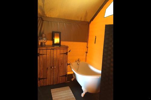 a bathroom with a white tub and a sink at Otium Oasis Glamping & Camping in Hartebeest Rivier