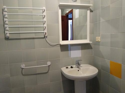 a bathroom with a sink and a mirror at A casa da Liberdade in Ourense