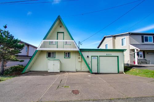 a house with a triangular roof with a garage at Pirate's Paradise in Lincoln City