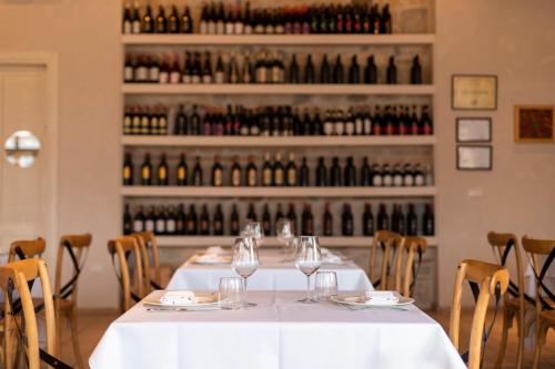 a table in a room with wine bottles at Agroturizem Gjepali in Shijak