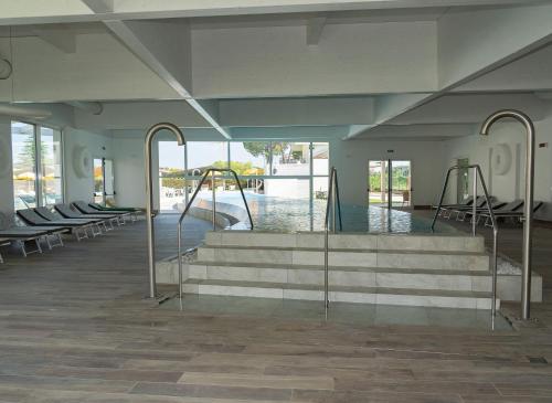 a swimming pool with stairs in a building at Hotel Terme Abano Verdi in Abano Terme